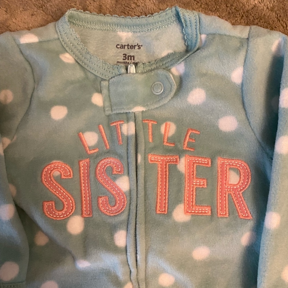 Pair of footed zip-up onesies.
